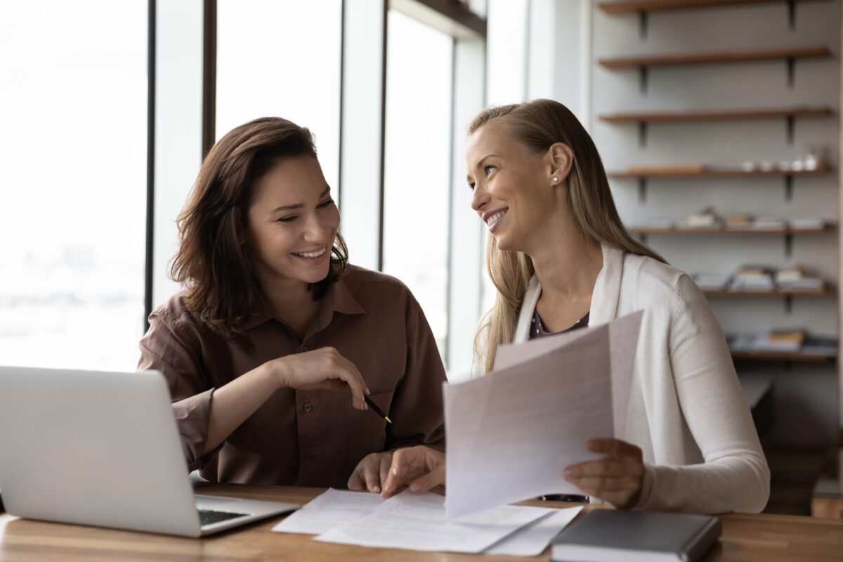 A tenant reviewing a commercial lease agreement with a legal advisor at a desk